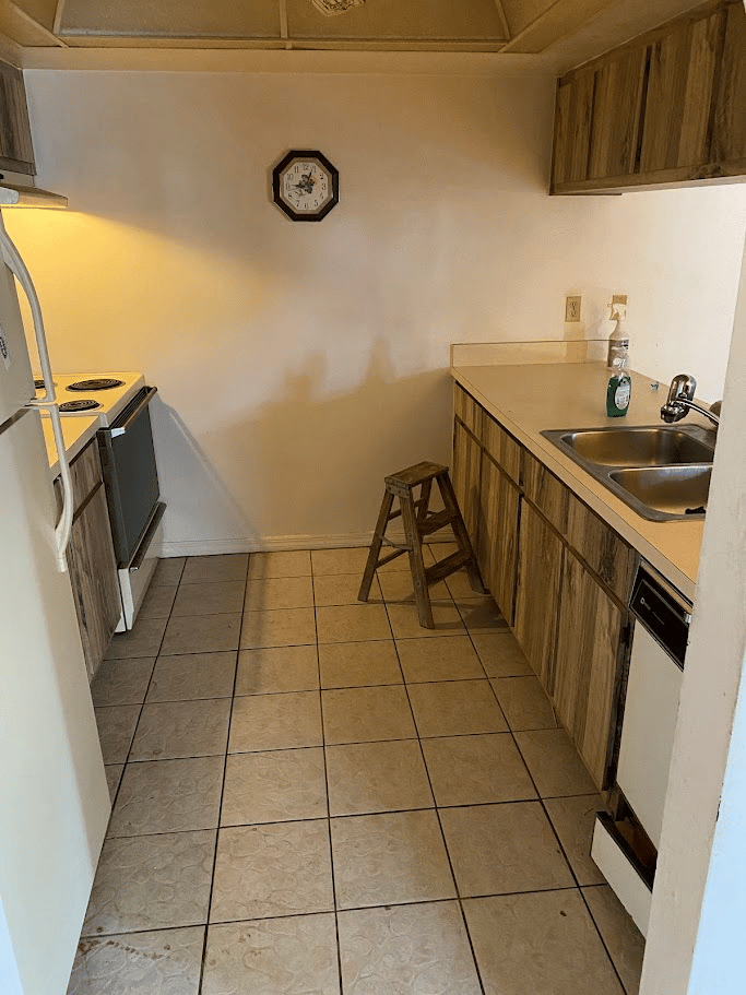 Small kitchen space cleared after appliance and cabinet removal