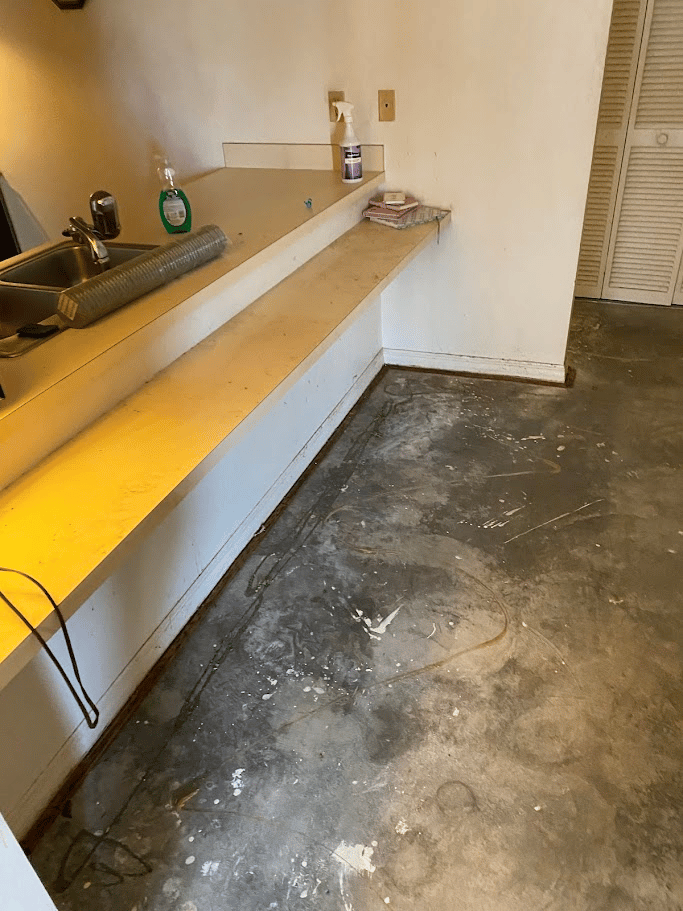 Kitchen space after interior cleanout with cleared floor and counters