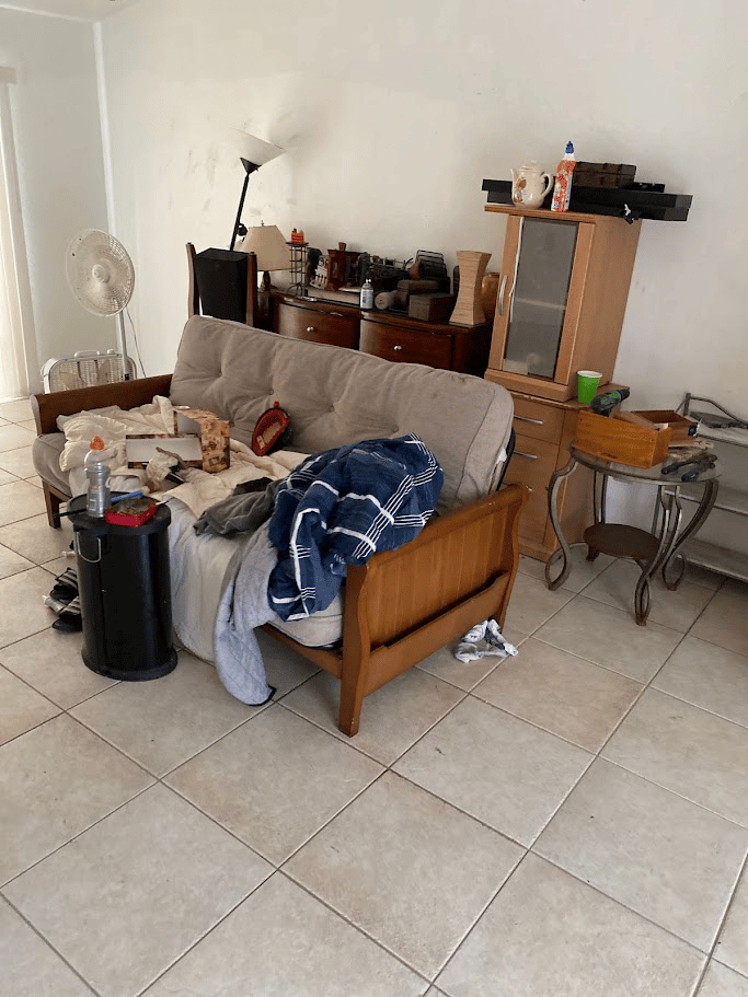Living room furniture and household items staged before residential junk removal