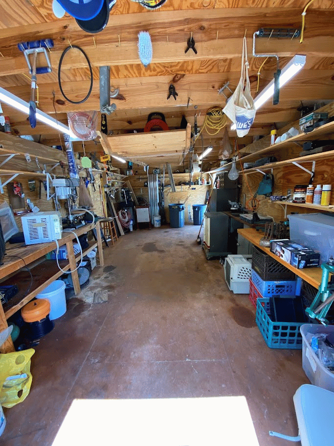 Wide-angle view of a clean and organized garage workshop with tools and shelves