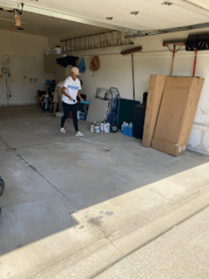 Garage cleanout in progress with items staged for removal by Pure Disposal