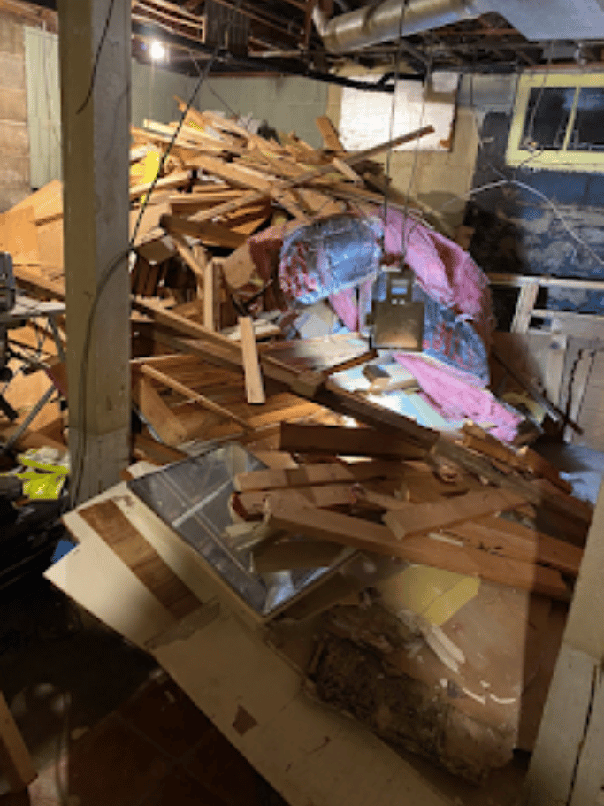 Interior demolition debris with wood framing, insulation, and construction waste removed by Pure Disposal