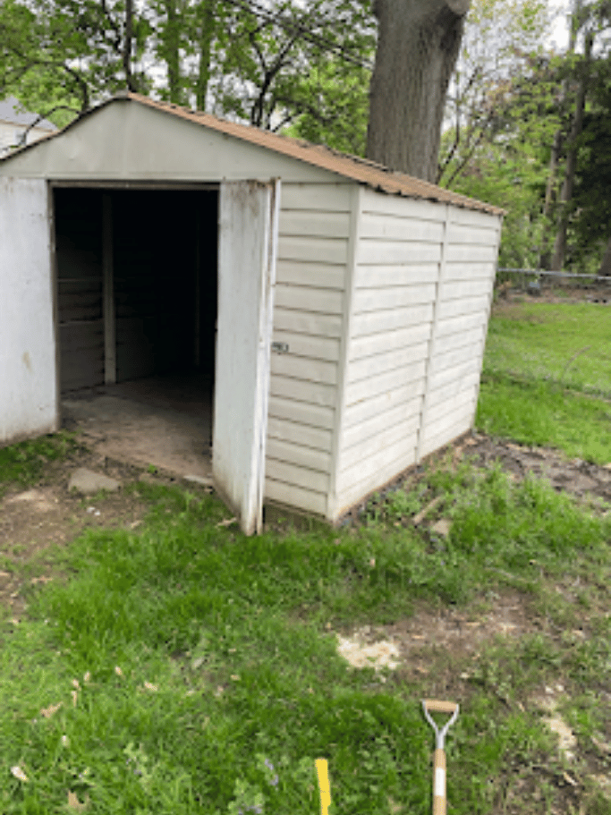 Empty backyard storage shed after junk removal and cleanout by Pure Disposal