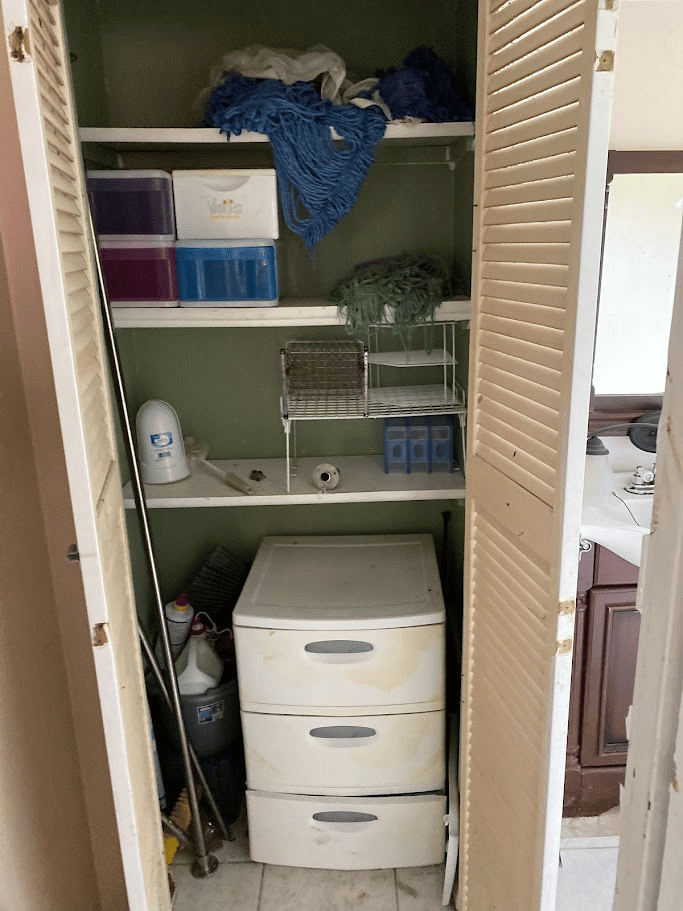 Utility closet with storage bins and cleaning supplies prepared for junk removal